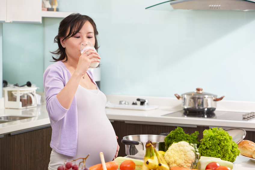 Pregnant lady drinking milk